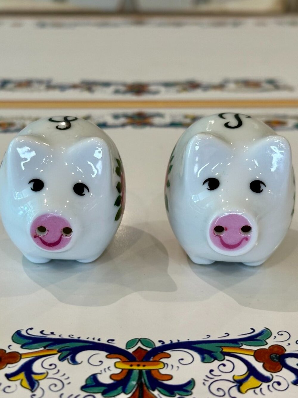 vintage ceramic pig-shaped salt and pepper shakers featuring pink floral pattern